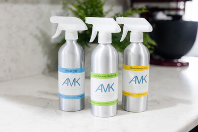 Cleaning solution with AMK Cleaning Services branded stickers