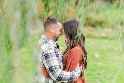 Engagement session photo of couple hugging in a field in Latrobe, PA