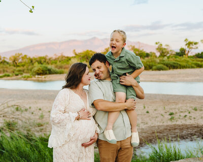 Experience the beauty of creative maternity photography in Albuquerque with this stunning image of a mom-to-be dressed in an amazing orange dress. Captured on the beach with the sea as a backdrop, this portrait perfectly combines elegance and natural beauty.