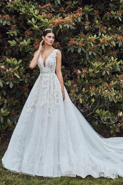 Beaded lace with floral appliques A-line silhouette V-neckline Pocket detail Structured bodice Dramatic cascading train