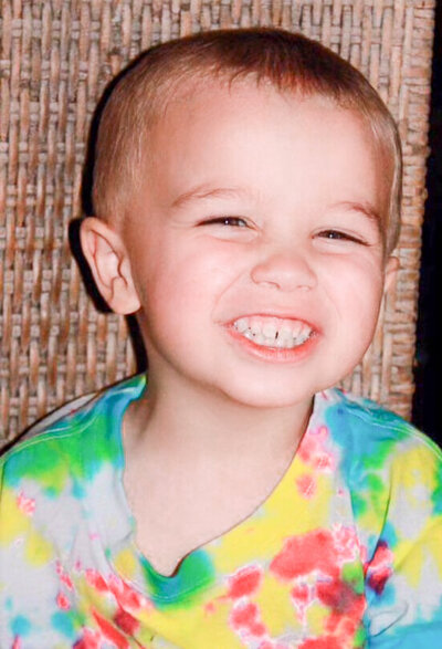 Parker James Berry wearing a colorful shirt smiling ear to ear