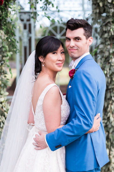 Bride and groom smiling at camera under gazebo at Texas venue