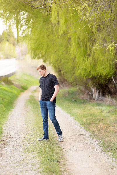 Senior boy walking along a path in Boise, ID.