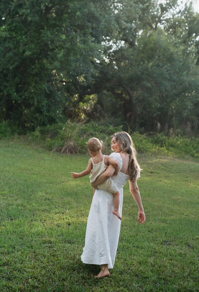 Mom holding child taken by Shelby Ann Photos, florida engagement photographers