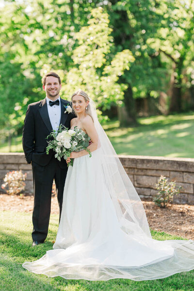 Bride and groom stand in front of Whitehall wedding venue in Louisville