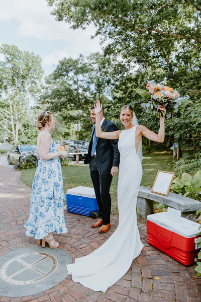 Documentary photo of the bride and groom with the Bridesmaid after the wedding ceremony. Split Rock Brewing. 