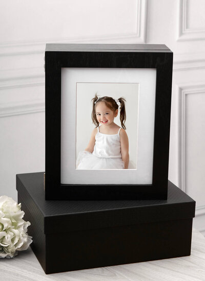 black wooden keepsake window box containing matted image of cute child with pigtails