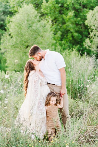 family embracing together in sunflower field