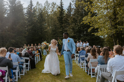 bride and groom walking back down the aisle after getting married