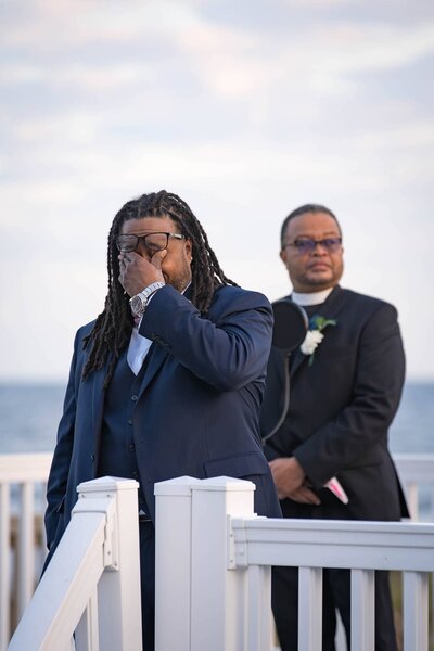 Groom crying at ceremony