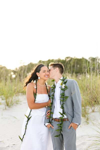 man kissing woman's cheek up close
