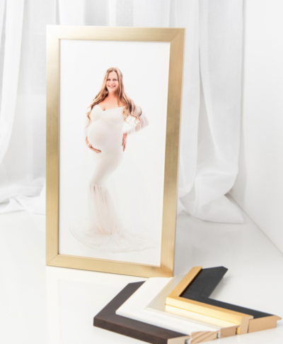 Gold frame of maternity session with mom using a white gown