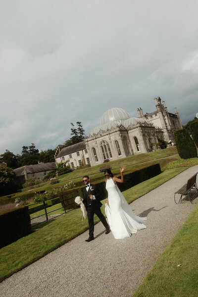 Bride and groom walking on path at Killruddery House and Gardens, Wicklow