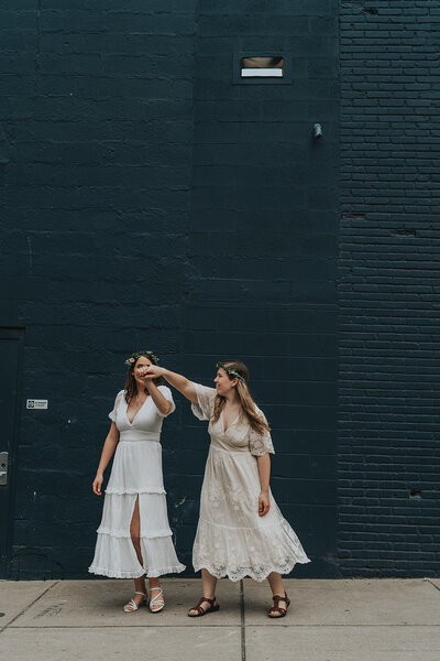 Two women dance together outside of an arcade in Nashville Tennessee