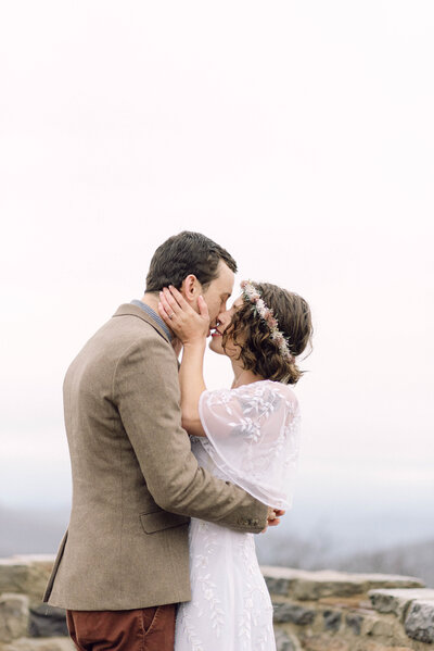 Brittanni and Derek sharing a kiss in their backyard wedding ceremony in Richmond, Virginia, documented with an editorial film aesthetic.