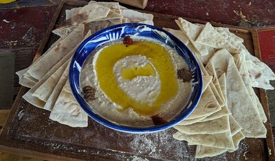 Hummus is a popular Middle Eastern dip or spread made from cooked and mashed chickpeas, blended with ingredients such as tahini (sesame paste), lemon juice, garlic, and olive oil.