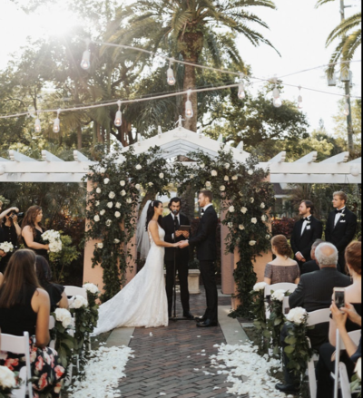 Outdoor Florida wedding ceremony with white details