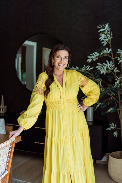 email marketing expert Amy Porterfield standing in a yellow dress