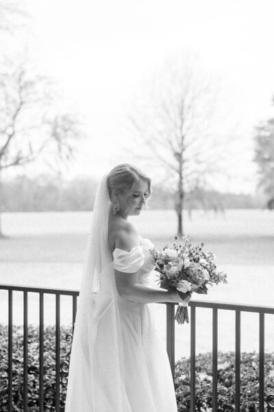 Alabama bride staring at her wedding bouquet — Madison Abernathy Photo 