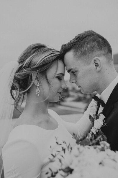 bride & groom joyfully smiling at the camera