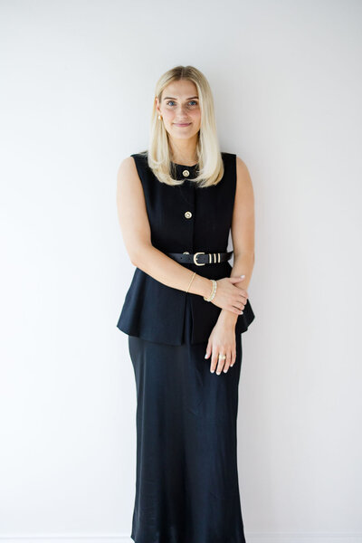 A member of the Aisle & Co. team poses for their headshot in black and white.