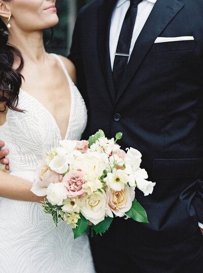 Close up of the bride's bouquet during a portrait together with the groom.