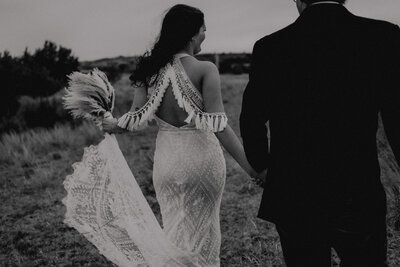 bride and groom walking away at their elopement in texas