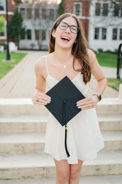 Best Worcester, MA college grad photographer shot of a happy college grad holding cap