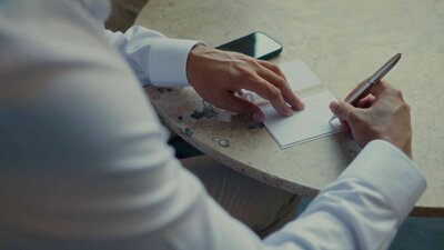 Groom handwriting vows in a Cancun villa before the ceremony.