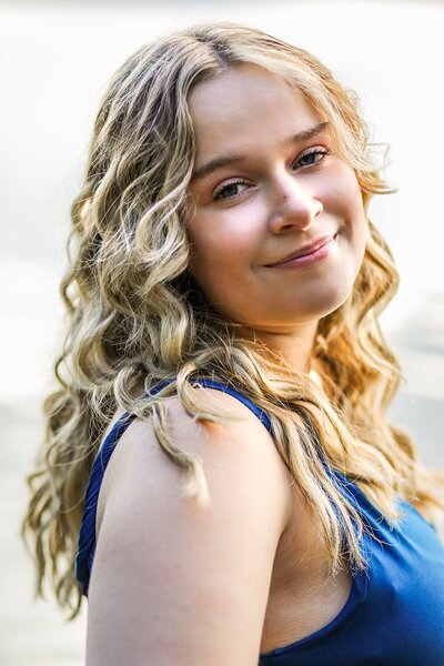 Photo of blonde girl in blue dress looking at camera | Senior Session