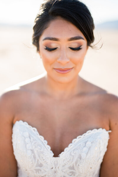A bride taking a moment to showcase her lashes as she stands in the middle of Eldorado Dry Lake Bed just outside of Las Vegas, Nevada.