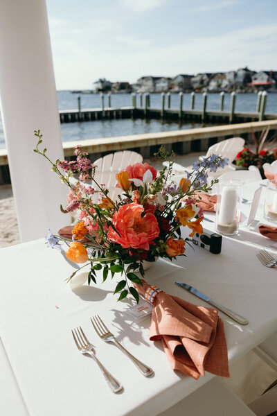 Exquisite wedding centerpiece with a mix of roses, peonies, and eucalyptus, showcasing Leigh Florist's stunning floral design expertise.