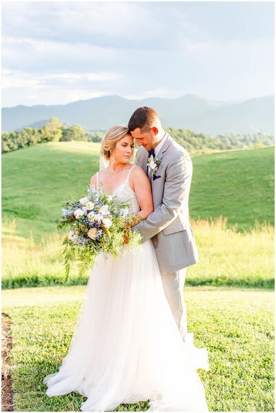 Newlyweds share a moment in the mountainous landscape of Greenville, North Carolina Asheville NC Wedding Photographer | Tracy Waldrop