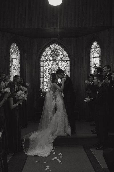 black and white photo of bride and groom during their church wedding ceremony