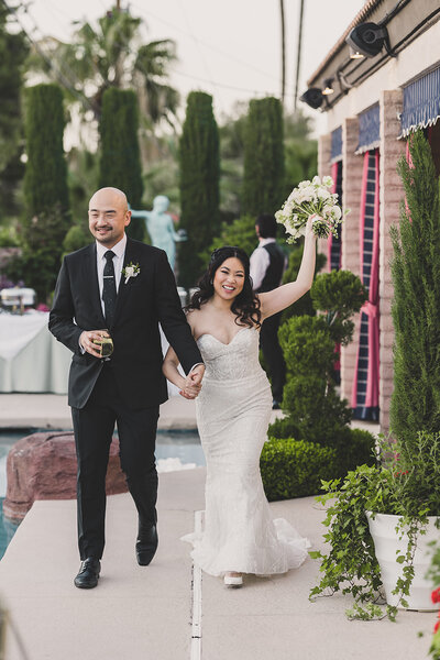 bride and groom hold hands after destination wedding ceremony