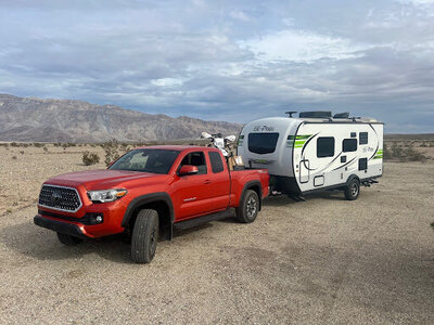 Red truck pulling a travel trailer