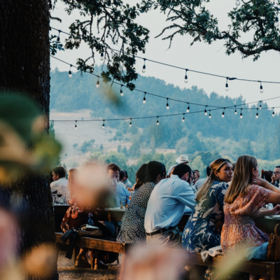 Outdoor wedding venue where people are sitting at tables