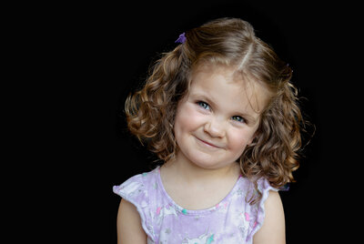 Little girl smirking during school portraits in Wheaton IL