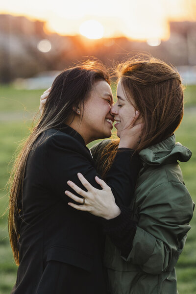 A couple with their arms around each other kissing 