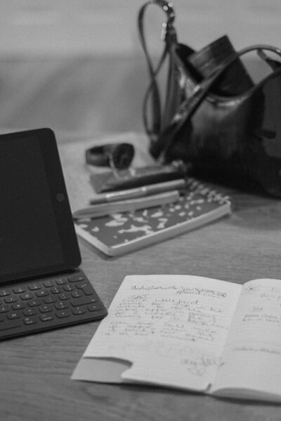 Image of a notebook and laptop, representing the production coaching services offered by Good Girl Bad Girl Studios. 