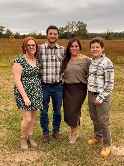 Ms. Brandi, the assistant director's family photo featuring Ms. Brandi, her husband and two children