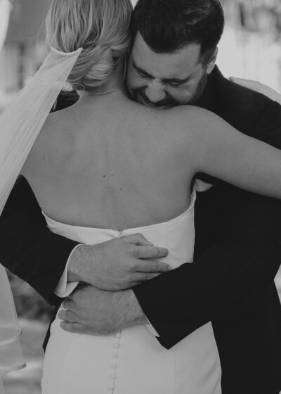 Bride and groom hugging during tearful first look