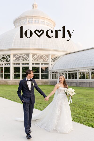groom and bride holding hands walking in front of the greenhouse at New York Botanical Gardens