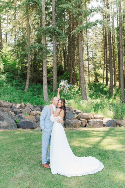 Bride and groom during their first look at Twin creeks farm Princeton Idaho wedding venue on a july wedding day