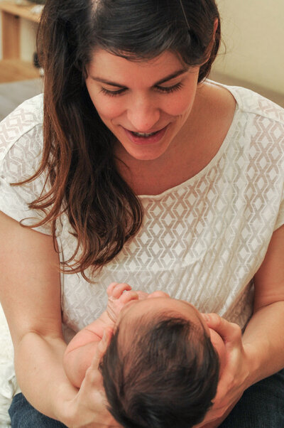 Rebeca Yasuda looking at newborn baby