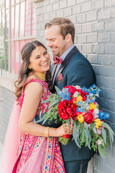 Lexington bride and groom smiling after their ceremony with beautiful flowers