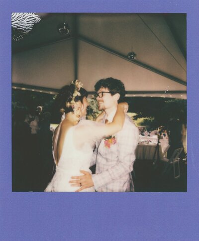 Close up of wedding invitation and other meaningful parts of the wedding, laid out on a table
