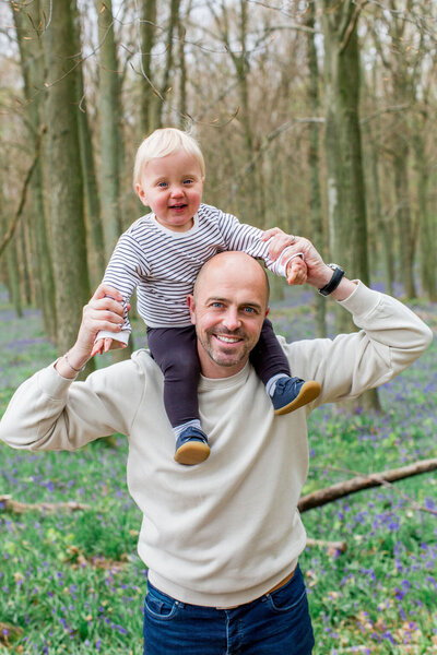 Young boy sat on Father's shoulders smiling during their London family Mini Shoot with Philippa Sian Photography
