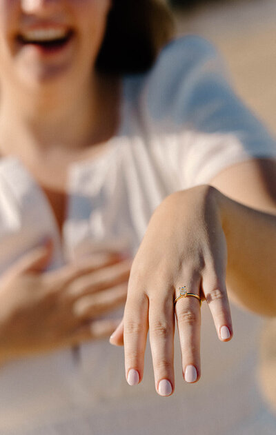 close up ring shot summer cape henlopen state park delaware beach proposal lgbt couple photo