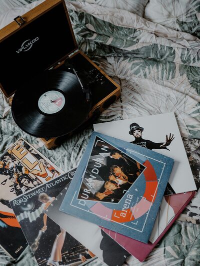 Collage of records and record player on bed